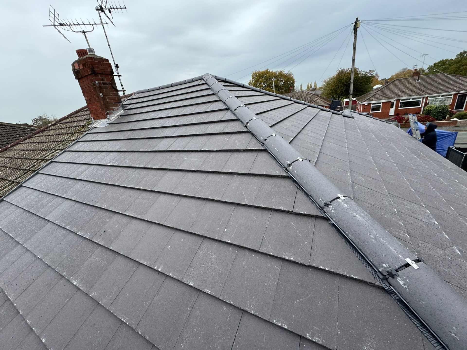New interlocking roof tiles with hip ridge detail on a residential property