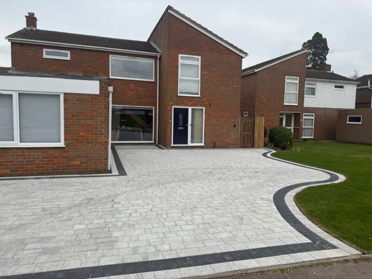 Silver block paving driveway with charcoal border on a detached property